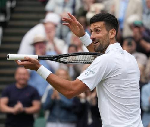 Lawn Tennis - 2024 Wimbledon Championship Mens Singles Semi Final - Novak Djokovic (SRB) v Lorenzo Musetti (ITA) All England Lawn Tennis & Croquet Club - Friday 12h July 2024 Novak Djokovic jokingly plays the Violin to the crowd after winning the match 