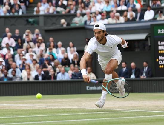 Lorenzo Musetti plays a backhand in his Men s Semi-Final match against Novak Djokovic at the 2024 Wimbledon Championships in London on Friday, July 12, 2024.  LON2024071248 HUGOxPHILPOTT