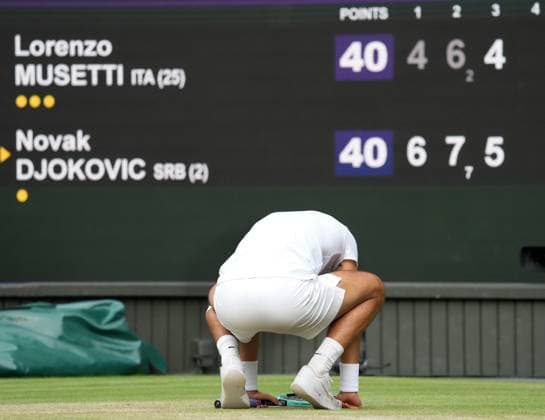 Lawn Tennis - 2024 Wimbledon Championship Mens Singles Semi Final - Novak Djokovic (SRB) v Lorenzo Musetti (ITA) All England Lawn Tennis & Croquet Club - Friday 12h July 2024 Lorenzo Musetti (ITA) drops to his knees after failing with a break point 