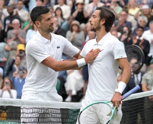 Lawn Tennis - 2024 Wimbledon Championship Mens Singles Semi Final - Novak Djokovic (SRB) v Lorenzo Musetti (ITA) All England Lawn Tennis & Croquet Club - Friday 12h July 2024 Novak Djokovic consoles Lorenzo Musetti at the net after the game 