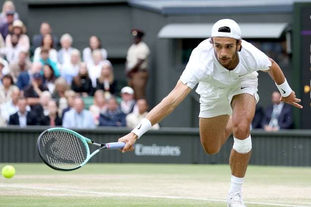 (240713) -- LONDON, July 13, 2024 -- Lorenzo Musetti hits a return during the men s singles simifinal match between Novak Djokovic of Serbia and Lorenzo Musetti of Italy at Wimbledon tennis Championship in London, Britain, on July 12, 2024. ) (SP)BRITAIN-LONDON-TENNIS-WIMBLEDON-MEN S SINGLES-SEMIFINALS LixYing 