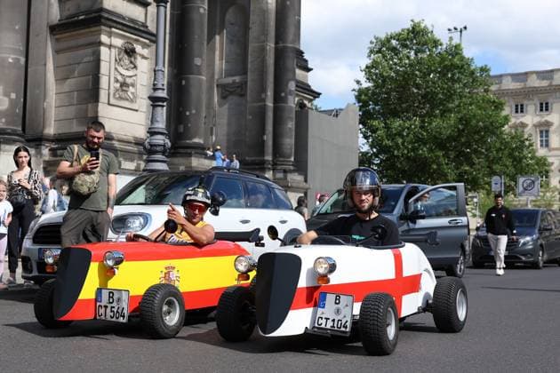 Berlin, Germany. 13th July 2024. England and Spain fans in small cars with national flags on prior to the final taking place in Berlin, Germany. Picture date: 13th July 2024. Picture Paul Terry Sportimage EDITORIAL USE ONLY. No use with unauthorised audio, video, data, fixture lists, club league logos or live services. Online in-match use limited to 120 images, no video emulation. No use in betting, games or single club league player publications. SPI-3231-0020