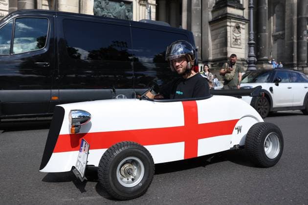 Berlin, Germany. 13th July 2024. England fan in small cars with national flag on prior to the final taking place in Berlin, Germany. Picture date: 13th July 2024. Picture Paul Terry Sportimage EDITORIAL USE ONLY. No use with unauthorised audio, video, data, fixture lists, club league logos or live services. Online in-match use limited to 120 images, no video emulation. No use in betting, games or single club league player publications. SPI-3231-0021