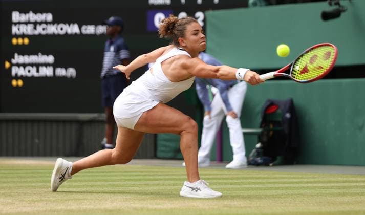 Jasmine Paolini plays a backhand in the Wimbledon Women s Final against Czech Barbora Krejcikova at the 2024 Wimbledon Championships in London on Saturday, July 13, 2024. Krejcikova won the match 6-2,2-6,6-4.  LON2024071334 HUGOxPHILPOTT