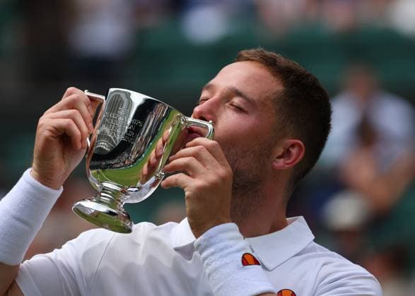 14th July 2024; All England Lawn Tennis and Croquet Club, London, England; Wimbledon Tennis Tournament, Day 14; Alfie Hewett (GBR) kisses the Gentlemen Wheelchair Singles trophy after defeating Martin De La Puente (ESP) in straight sets  ActionPlus12667776 JohnxPatrickxFletcher