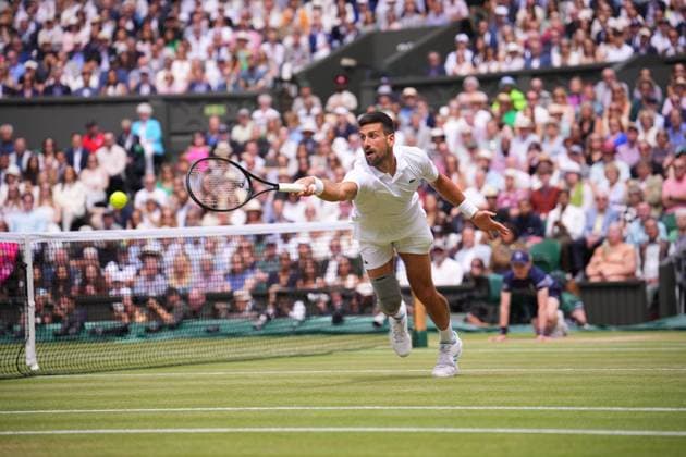 LONDON, ENGLAND - JULY 14: Novak Djokovic of Serbia plays a backhand volley against Carlos Alcaraz of Spain in the Gentlemen s Singles Final during day fourteen of The Championships Wimbledon 2024 at All England Lawn Tennis and Croquet Club on July 14, 2024 in London, England  Copyright: xHiroshixSatox