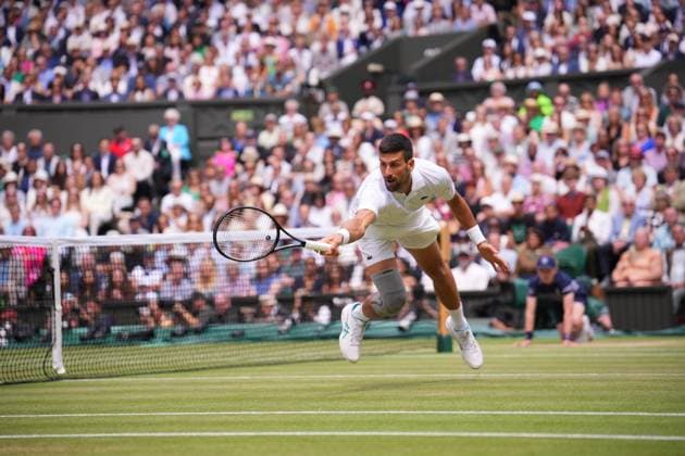 LONDON, ENGLAND - JULY 14: Novak Djokovic of Serbia plays a backhand volley against Carlos Alcaraz of Spain in the Gentlemen s Singles Final during day fourteen of The Championships Wimbledon 2024 at All England Lawn Tennis and Croquet Club on July 14, 2024 in London, England  Copyright: xHiroshixSatox