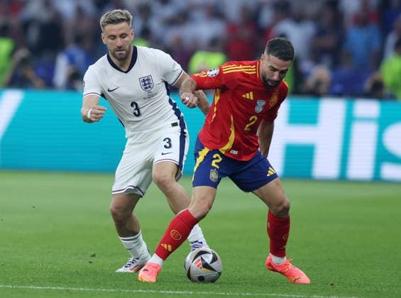 Berlin, Germany, 14th July 2024. Luke Shaw of England (L) challenges Dani Carvajal of Spain during the UEFA European Championships final match at Olympiastadion, Berlin. Picture: Paul Terry Sportimage EDITORIAL USE ONLY. No use with unauthorised audio, video, data, fixture lists, club league logos or live services. Online in-match use limited to 120 images, no video emulation. No use in betting, games or single club league player publications. SPI-3227-0060