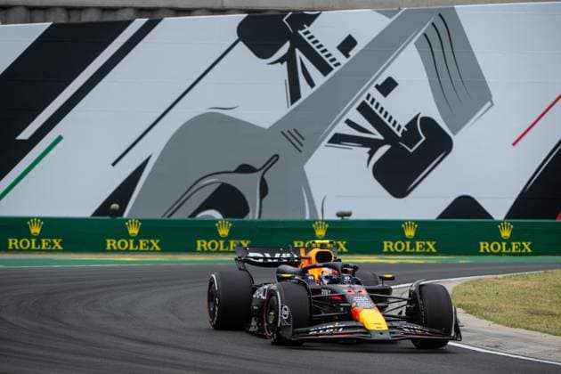 Sergio Checo Perez Oracle Red Bull Racing, Mexico, 11 in the RedBull RB20 in front of a painting of a silver Formula 1 car and Rolex branding, HUN, Formula 1 World Championship, Hungarian Grand Prix, Hungaroring, Free Practice, 20 07 2024 HUN, Formula 1 World Championship, Hungarian Grand Prix, Hungaroring, Free Practice, 20 07 2024 Mogyorod Copyright: xEibner-Pressefoto Memmlerx EP_MMR
