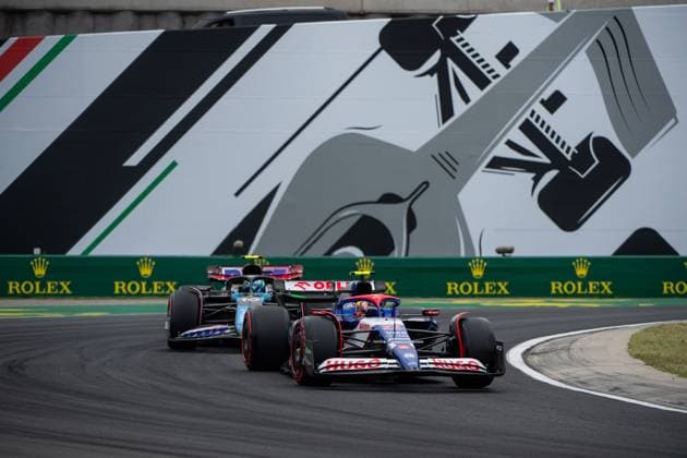 Yuki Tsunoda Visa Cash App RB Formula One Team Racing Bulls, Japan, 22 in VCARB 01 in front ofPierre Gasly BWT Alpine F1 Team, France, 10 in front of the painting of a silver Formula 1 car and Rolex branding, HUN, Formula 1 World Championship, Hungarian Grand Prix, Hungaroring, Free Practice, 20 07 2024 HUN, Formula 1 World Championship, Hungarian Grand Prix, Hungaroring, Free Practice, 20 07 2024 Mogyorod Copyright: xEibner-Pressefoto Memmlerx EP_MMR