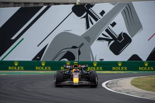 Sergio Checo Perez Oracle Red Bull Racing, Mexico, 11 in the RedBull RB20 in front of a painting of a silver Formula 1 car and Rolex branding, HUN, Formula 1 World Championship, Hungarian Grand Prix, Hungaroring, Free Practice, 20 07 2024 HUN, Formula 1 World Championship, Hungarian Grand Prix, Hungaroring, Free Practice, 20 07 2024 Mogyorod Copyright: xEibner-Pressefoto Memmlerx EP_MMR