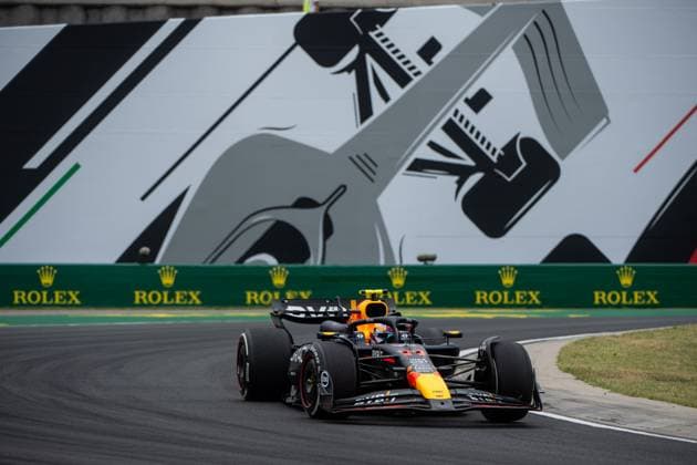 Sergio Checo Perez Oracle Red Bull Racing, Mexico, 11 in the RedBull RB20 in front of a painting of a silver Formula 1 car and Rolex branding, HUN, Formula 1 World Championship, Hungarian Grand Prix, Hungaroring, Free Practice, 20 07 2024 HUN, Formula 1 World Championship, Hungarian Grand Prix, Hungaroring, Free Practice, 20 07 2024 Mogyorod Copyright: xEibner-Pressefoto Memmlerx EP_MMR
