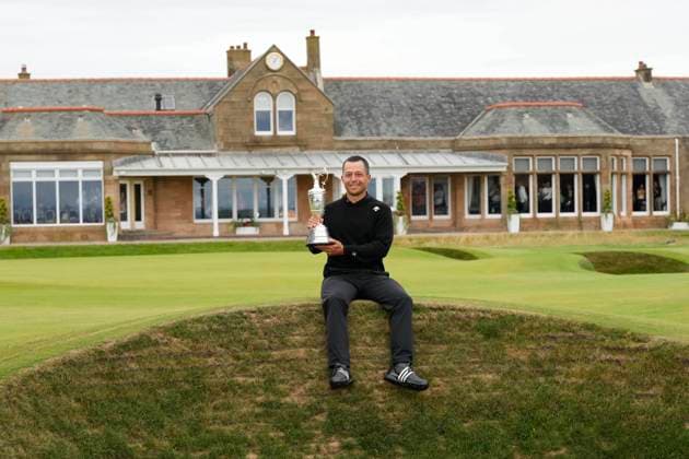 21st July 2024; Royal Troon Golf Club, Troon, South Ayrshire, Scotland; The Open Championship Final Round; Xander Schauffele sits on a bunker with the Claret Jug in front of the Royal Troon Clubhouse  ActionPlus12671129 StevenxFlynn
