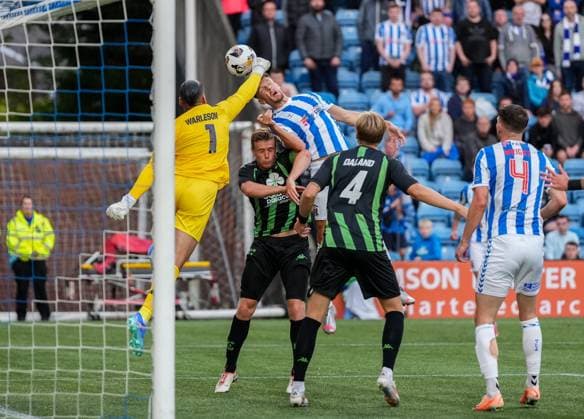 Cercle Brugge goalkeeper Warleson punches the ball away from the head of Brad Lyons of Kilmarnock. Kilmarnock v Cercle Brugge, UEFA Europa League, 2nd Qualifying Round, Football, The BBSP Stadium Rugby Park, Kilmarnock, UK, 25 Jul 2024 EDITORIAL USE ONLY No use with unauthorised audio, video, data, fixture lists, club league logos or live services. Online in-match use limited to 120 images, no video emulation. No use in betting, games or single club league player publications. Copyright: xStuartxWallace Shutterstockx 14602352cp