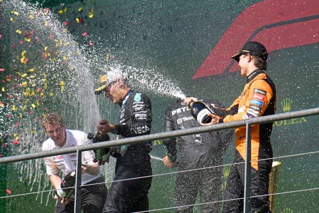 Mercedes-AMG Petronas UK rider George Russell (C) celebrates on the podium after winning the Grand Prix F1 of Belgium race, in Spa-Francorchamps, Sunday 28 July 2024. The Spa-Francorchamps Formula One Grand Prix takes place this weekend, from July 25th to July 28th. JONASxROOSENS  x97243489x