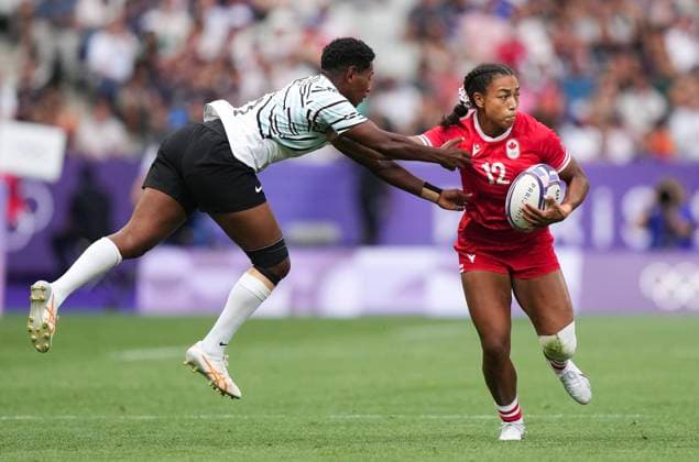 July 28, 2024, Paris, FRANCE: Canada back Keyara Wardley (12) fights off the tackle from Fiji back Ana Maria Naimasi (6) during second half Women rugby 7s rugby action at the Paris Summer Olympics in Paris, France on Sunday, July 28, 2024. Canada News - July 28, 2024  - ZUMAc35_ 20240728_zaf_c35_060 Copyright: xNathanxDenettex