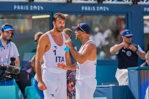 July 28, 2024, Paris, Ile de France, France: ALEX RANGHIERI (ITA) (1) and ADRIAN IGNACIO CARAMBULA RAURICH (ITA) (2) discuss stragedy during their Preliminary Phase - Pool B Mens Beach volleyball, Beachvolleyball match against Team Netherlands (NED) at the Stade Tour Eiffel stadium during the 2024 Paris Summer Olympics in Paris, France. Paris France - ZUMAa161 20240728_oly_a161_100 Copyright: xWalterxArcex