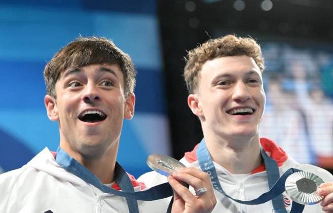 29th July 2024; Paris Olympic Games, Olympische Spiele, Olympia, OS Paris, France, Day 4; Aquatics Centre, Mens Synchronised 10m Platform diving final, Tom Daley and Noah Williams display their silver medals while Tom reacts to Noah kissing him on the cheek  ActionPlus12674111 SimonxWest