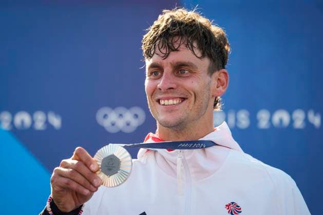 Adam Burgess of Team Great Britain smiles with his silver medal during the podium ceremony for the Men s C1 Canoe Slalom final at the Vaires-sur-Marne Nautical Stadium outside Paris during the 2024 Paris Summer Olympic Games, Olympische Spiele, Olympia, OS in Paris, France, Monday, July 29, 2024.  OLY20240729408 PaulxHanna