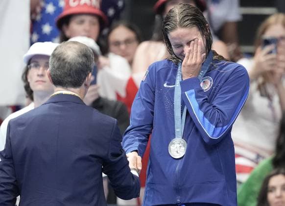 Silver medalist Katie Grimes of the U.S. reacts after receiving her medal in the Women s 400m Individual Medley Final at the Paris 2024 Olympics at the Arena Le Defense in Paris, France on Monday, July 29, 2024. Summer McIntosh of Canada won the gold, Katie Grimes of the U.S. won silver and Emma Weyant of the U.S. won the bronze.  OLY202407291588 RICHARDxELLIS