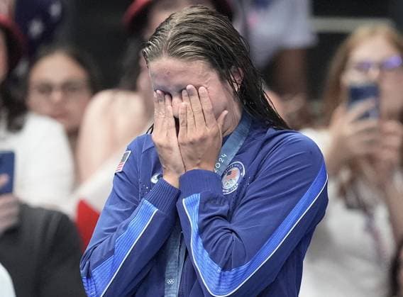 Silver medalist Katie Grimes of the U.S. reacts after receiving her medal in the Women s 400m Individual Medley Final at the Paris 2024 Olympics at the Arena Le Defense in Paris, France on Monday, July 29, 2024. Summer McIntosh of Canada won the gold, Katie Grimes of the U.S. won silver and Emma Weyant of the U.S. won the bronze.  OLY202407291589 RICHARDxELLIS