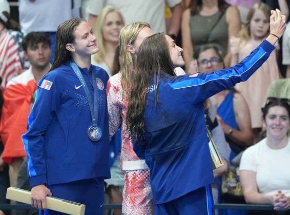 Gold medalist Summer McIntosh of Canada (C), silver medalist Katie Grimes of the U.S. (L) and bronze medalist Emma Weyant of the U.S. stand on the podium after the Women s 400m Individual Medley Final at the Paris 2024 Olympics at the Arena Le Defense in Paris, France on Monday, July 29, 2024.  OLY202407291597 RICHARDxELLIS