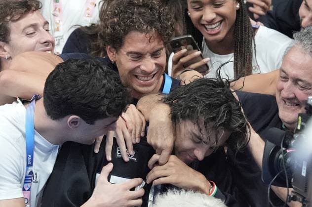 Gold medalist Thomas Ceccon of Italy is congratulated by family and friends after the Men s 100m Backstroke Finals at the Paris 2024 Olympics at the Arena Le Defense in Paris, France on Monday, July 29, 2024.  OLY202407291628 RICHARDxELLIS