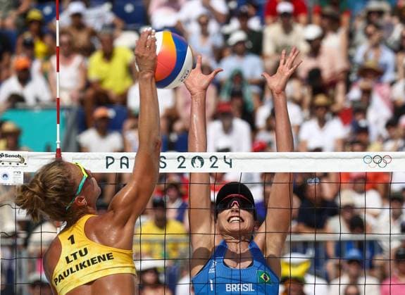 RUSSIA, PARIS - JULY 30, 2024: Brazil s Carolina Solberg Salgado (R) and Lithuania s Monika Paulikene play a womenâ€™s Pool E Beach volleyball, Beachvolleyball match during the 2024 Summer Olympics at the Eiffel Tower Stadium on the Champ de Mars. Alexander Shcherbak TASS  72546292