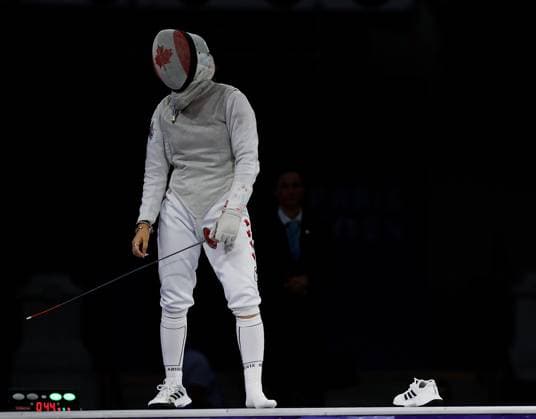 (240801) -- PARIS, Aug. 1, 2024 -- Guo Jessica Zi Jia of Canada reacts after one of her shoes came off as she competes against Kikuchi Komaki of Japan during the women s foil team bronze medal match of fencing between Canada and Japan at the Paris 2024 Olympic Games, Olympische Spiele, Olympia, OS in Paris, France, Aug. 1, 2024. ) (PARIS2024) FRANCE-PARIS-OLY-FENCING FeixMaohua 
