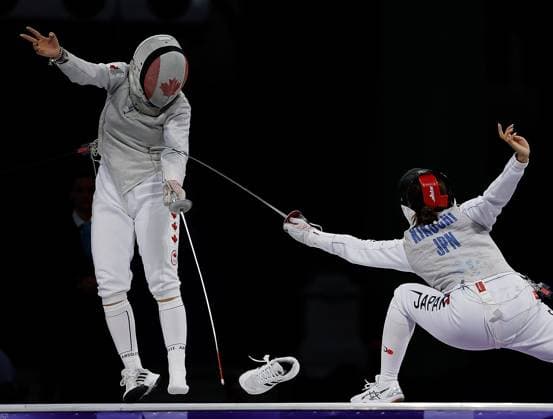 (240801) -- PARIS, Aug. 1, 2024 -- One shoe of Guo Jessica Zi Jia (L) of Canada comes off as she competes against Kikuchi Komaki of Japan during the women s foil team bronze medal match of fencing between Canada and Japan at the Paris 2024 Olympic Games, Olympische Spiele, Olympia, OS in Paris, France, Aug. 1, 2024. ) (PARIS2024) FRANCE-PARIS-OLY-FENCING FeixMaohua 