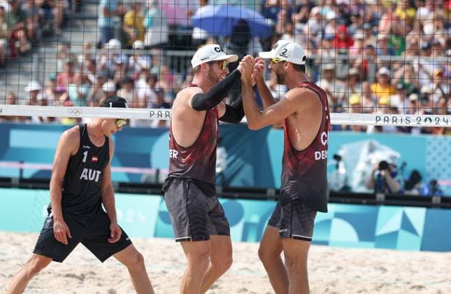 (240802) -- PARIS, Aug. 2, 2024 -- Samuel Schachter (C) Daniel Dearing (R) of Canada celebrate after the men s preliminary phase pool E of Beach volleyball, Beachvolleyball between Julian Hoerl Alexander Horst of Austria and Samuel Schachter Daniel Dearing of Canada at the Paris 2024 Olympic Games, Olympische Spiele, Olympia, OS in Paris, France, Aug. 2, 2024. ) (PARIS2024) FRANCE-PARIS-OLY-BEACH VOLLEYBALL HuangxZongzhi 