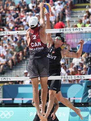 (240802) -- PARIS, Aug. 2, 2024 -- Daniel Dearing (L) of Canada competes against Julian Hoerl of Austria during the men s preliminary phase pool E of Beach volleyball, Beachvolleyball between Julian Hoerl Alexander Horst of Austria and Samuel Schachter Daniel Dearing of Canada at the Paris 2024 Olympic Games, Olympische Spiele, Olympia, OS in Paris, France, Aug. 2, 2024. ) (PARIS2024) FRANCE-PARIS-OLY-BEACH VOLLEYBALL HuangxZongzhi 