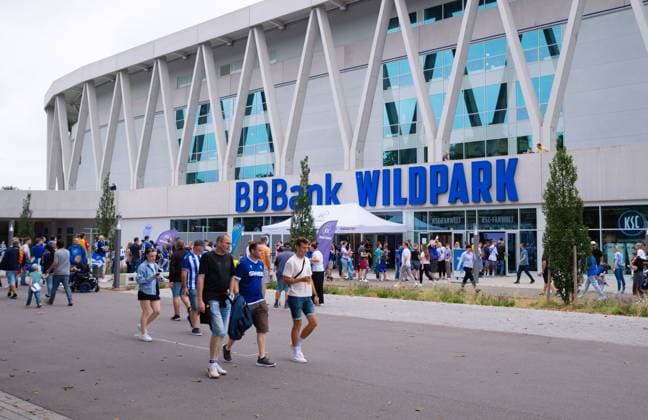 Fans of Karlsruher SC in front of the Wildparkstadion, 2 Bundesliga, Karlsruher SC vs 1 FC Nuernberg, BBBank Wildpark on August 03, 2024 in Karlsruhe, Germany Photo by Silas Schueller DeFodi Images fans of Karlsruher SC walk in front of the stadium, 2 Bundesliga, Karlsruher SC vs 1 FC Nuernberg, BBBank Wildpark on August 3, 2024 in Karlsruhe, Germany Photo by Silas Schueller DeFodi Images Defodi 738 738 KSCFCN 20240803 120 Defodi-738