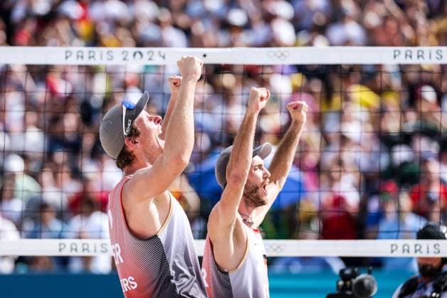 FRA, Paris, Olympic Games Paris 2024, 03 08 2024, Beach Volleyball Mens Round of 16, Eiffel Tower Centre Court Nils Ehlers Germany, 1 and Clemens Wickler Germany, 2 against George Souto Maior Wanderley Brazil, 1 and Andre Loyola Stein Brazil, 2 Clemens Wickler Germany, 2 and Nils Ehlers Germany, 1 celebrate after the victory Copyright: HMBxMedia SteffiexWunderl