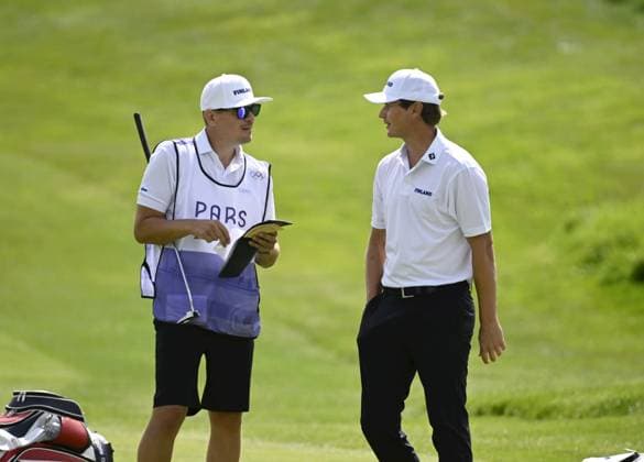 Tapio Pulkkanen of Finland (R) competes with caddie Riku Mattila during men s individual stroke play of golf at the Paris Summer Olympic Games, Olympische Spiele, Olympia, OS in Le Golf National on August 4, 2024. Paris France LKFTJK20240804131739JYOY  Copyright: xAnttixAimo-Koivistox LKFTJK20240804131739JYOY