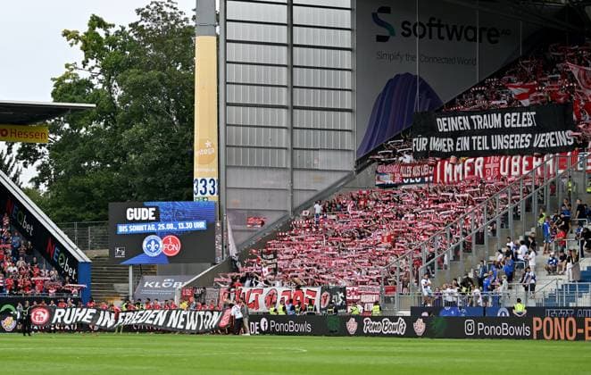 04 08 2024, xfux, Fußball 2 Bundesliga, SV Darmstadt 98 Fortuna Düsseldorf emspor, v l Fans Fortuna Duesseldorf Stimmung, Trikot, Schal, Fahne und Fans Fortuna Duesseldorf Stimmung, Trikot, Schal, Flag commemorate the deceased player of Fortuna Düsseldorf Newton Opoku Mensah DFL DFB REGULATIONS PROHIBIT ANY USE OF PHOTOGRAPHS as IMAGE SEQUENCES and or QUASI VIDEO No release of or sale to SV Darmstadt 1898 e V Darmstadt is permitted.