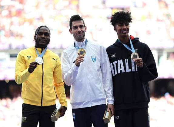 (240807) -- PARIS, Aug. 7, 2024 -- Gold medalist Miltiadis Tentoglou (C) of Greece, silver medalist Wayne Pinnock (L) of Jamaica and bronze medalist Mattia Furlani of Italy react during the victory ceremony of the men s long jump of Athletics at the Paris 2024 Olympic Games, Olympische Spiele, Olympia, OS in Paris, France, Aug. 7, 2024. ) (PARIS2024) FRANCE-PARIS-OLY-ATHLETICS-LONG JUMP-MEN LixGang 