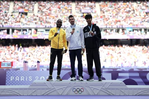 (240807) -- PARIS, Aug. 7, 2024 -- Gold medalist Miltiadis Tentoglou (C) of Greece, silver medalist Wayne Pinnock (L) of Jamaica and bronze medalist Mattia Furlani of Italy react during the victory ceremony of the men s long jump of Athletics at the Paris 2024 Olympic Games, Olympische Spiele, Olympia, OS in Paris, France, Aug. 7, 2024. ) (PARIS2024) FRANCE-PARIS-OLY-ATHLETICS-LONG JUMP-MEN LixGang 