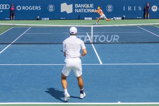 August 8, 2024, Montreal, Quebec, Canada: STEFANOS TSITSIPAS from Greece returning ball in first set against Kei Nishikori from Japan in second round of Canadian Open at IGA Stadium in Montreal, Quebec, Canada. View from opposite side of the court with Kei Nishikori from Japan blur in the foreground Montreal Canada - ZUMAl189 20240808_zsp_l189_024 Copyright: xYannickxLegarex