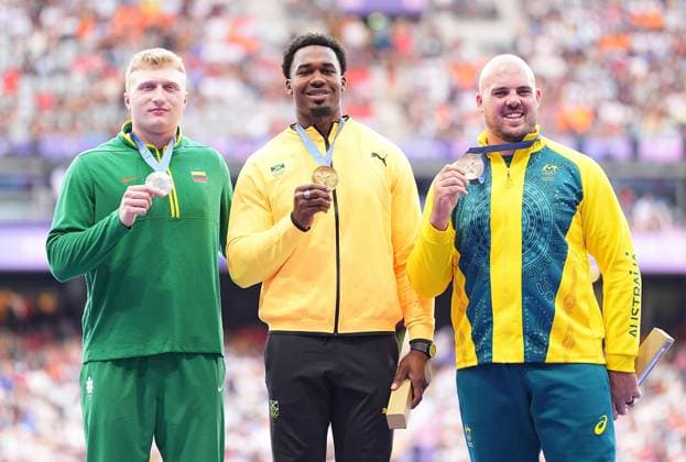 (240808) -- PARIS, Aug. 8, 2024 -- Gold medalist Roje Stona (C) of Jamaica, silver medalist Mykolas Alekna (L) of Lithuania and bronze medalist Matthew Denny of Australia react during the victory ceremony of the men s discus throw of Athletics at the Paris 2024 Olympic Games, Olympische Spiele, Olympia, OS in Paris, France, Aug. 8, 2024. ) (PARIS2024) FRANCE-PARIS-OLY-ATHLETICS-DISCUS THROW-MEN XuxChang 