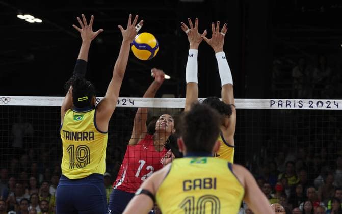 Team USA (red jersey) plays against Team Brazil (yellow jersey) during the Women s Volleyball semi-final of the 2024 Summer Olympics at the South Arena, in Paris, France, on Thursday, August 8, 2024. Team USA qualified for the final.  OLY20240808617 MAYAxVIDON-WHITE