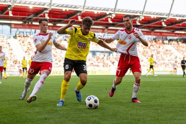 09 08 2024, Soccer, GER, Season, 2 Liga, Season 2024 2025, SSV Jahn Regensburg SSV Ulm 1846 Soccer Maurice Krattenmacher on the ball in front of Oscar Schönfelder SSV Jahn Regensburg and Christian Viet SSV Jahn Regensburg DFL REGULATIONS PROHIBIT ANY USE OF PHOTOGRAPHS AS IMAGE SEQUENCES AND OR QUASI VIDEO Regensburg Bayern Germany Jahnstadion Regensburg