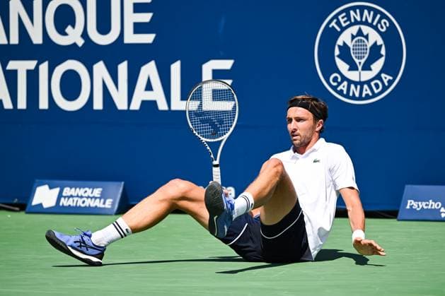 MONTREAL, QC - AUGUST 10: Arthur Rinderknech (FRA) falls on the ground after missing his shot during a second round match at ATP, Tennis Herren National Bank Open on August 10, 2024 at IGA Stadium in Montreal, QC (Photo by David Kirouac Icon Sportswire) TENNIS: AUG 10 National Bank Open EDITORIAL USE ONLY Icon240810020
