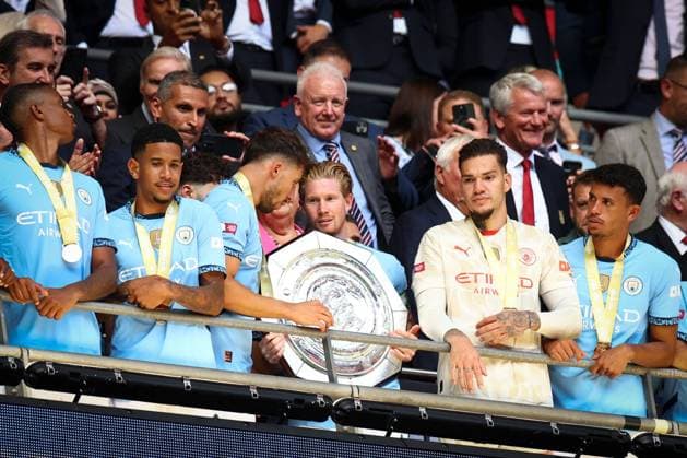 Kevin de Bruyne of Manchester City and Ruben Dias of Manchester City prepare to lift the Community Shield Manchester City v Manchester United, ManU FA Community Shield, Football, Wembley Stadium, London, UK, 10 Aug 2024 EDITORIAL USE ONLY No use with unauthorised audio, video, data, fixture lists, club league logos or live services. Online in-match use limited to 120 images, no video emulation. No use in betting, games or single club league player publications.  Copyright: xSimonxDael Shutterstockx 14623051fk