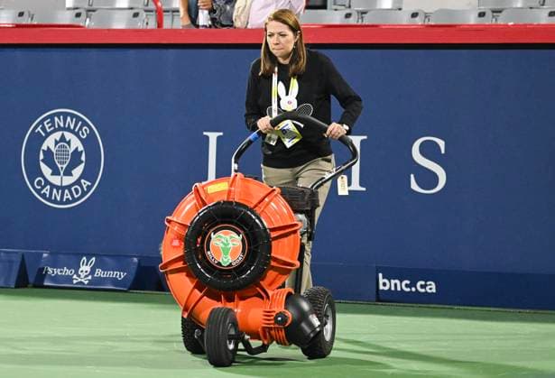 August 10, 2024, Montreal, Pq, Canada: Tournament director Valerie Tetreault helps dry centre court at the National Bank Open tennis tournament in Montreal, Saturday, August 10, 2024. Valérie Tétreault,  - ZUMAc35_ 20240810_zaf_c35_298 Copyright: xGrahamxHughesx