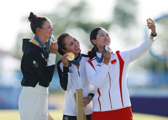 (240810) -- SAINT-QUENTIN-EN-YVELINES, Aug. 10, 2024 -- Gold medalist Lydia Ko (C) of New Zealand, silver medalist Esther Henseleit (L) of Germany and bronze medalist Lin Xiyu of China pose for a selfie during the victory ceremony for the women s golf individual stroke play at the Paris 2024 Olympic Games, Olympische Spiele, Olympia, OS in Saint-Quentin-en-Yvelines, France, Aug. 10, 2024. ) (PARIS2024) FRANCE-SAINT-QUENTIN-EN-YVELINES-OLY-GOLF RenxZhenglai 