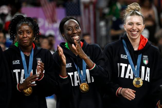 Myriam Fatime Sylla, Paola Ogechi Egonu and Sarah Luisa Fahr of Italy celebrate at the end of the Volleyball gold medal match between United States of America and Italy of the Paris 2024 Olympic Games, Olympische Spiele, Olympia, OS at Arena Paris Sud 1 in Paris (France), August 11, 2024. Italy defeated United States 3-0 and won the gold medal.