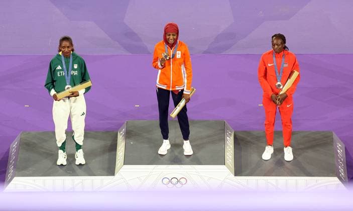 (240811) -- PARIS, Aug. 11, 2024 -- Gold medalist Sifan Hassan (C) of the Netherlands, silver medalist Tigst Assefa (L) of Ethiopia and bronze medalist Hellen Obiri of Kenya pose for photos during the victory ceremony of women s marathon of Athletics at the closing ceremony of the Paris 2024 Olympic Games, Olympische Spiele, Olympia, OS at the Stade de France in Paris, France, Aug. 11, 2024. ) (PARIS2024) FRANCE-PARIS-OLY-CLOSING CEREMONY LaixXiangdong 