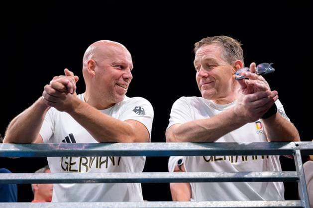 Paris, France Handball Olympic Mens Final Germany Denmark from left DHB Board Member Sport Axel Kromer, Coach Alfred Gislason Germany smiling smiling smiling smiling Lille Stade Pierre Mauroy France