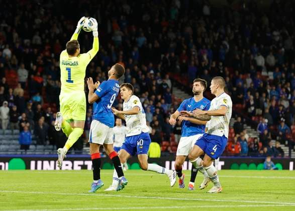 Rangers v FC Dynamo Kyiv UEFA Champions League Georgiy Bushchan of FC Dynamo Kyiv catches a cross under pressure from Cyriel Dessers of Rangers during the UEFA Champions League Third Qualifying Round Second Leg match at Hampden Park, Glasgow UK Newspapers OUT Copyright: xFredxPalmerx FIL-20489-0131